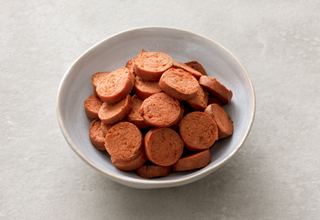 Sliced vegan sausage topping